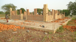 Front View of Guesthouse. Beginning to pour beams which will hold the roof.