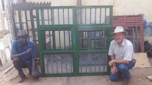 Here I am with the welder who built our first window. The top has a screened vent and the bottom windows lift upward. This style is unknown here. Their windows do not have screens and most swing out with the burglar bars on the inside. After many drawings and talks we got it made. There still a few kinks to work out but we are there. Now to get several bids from the locals as well as one contact in Kampala. The Guesthouse has good number of windows.